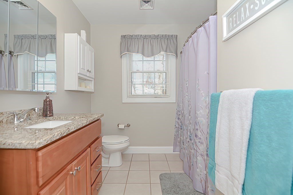 1066 Spencer Street Fall River, MA 02721 - Photo 24 of 35 a bathroom with a granite countertop sink toilet and shower