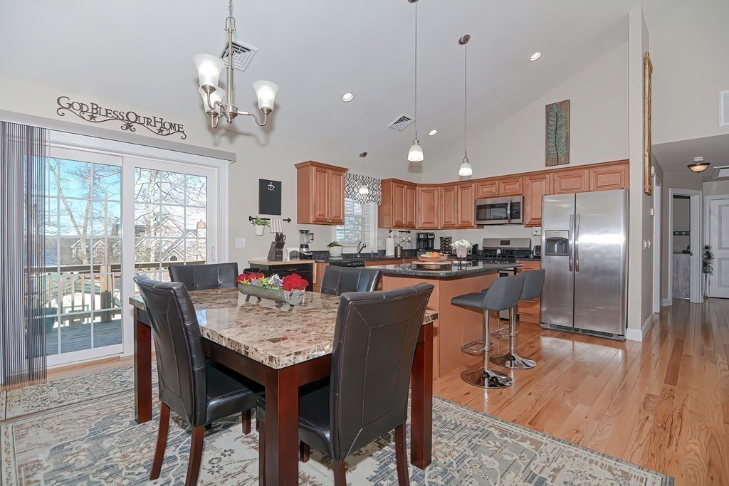 1066 Spencer Street Fall River, MA 02721 - Photo 6 of 35 a kitchen with stainless steel appliances granite countertop a stove a refrigerator a kitchen island a dining table and chairs