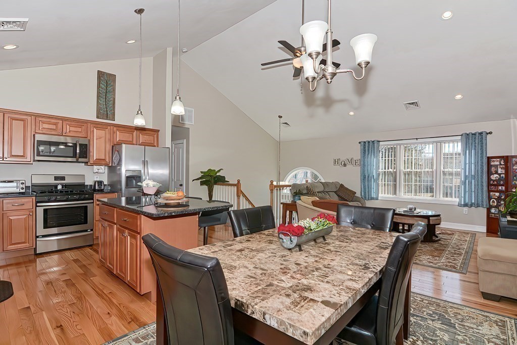 1066 Spencer Street Fall River, MA 02721 - Photo 7 of 35 a view of a dining room with furniture a kitchen and chandelier