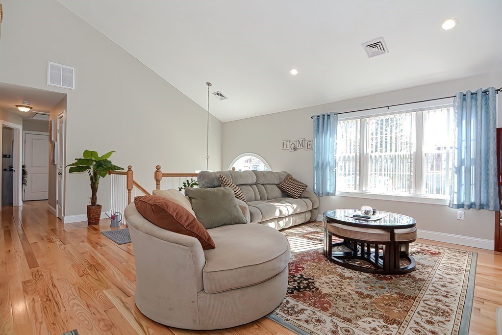 1066 Spencer Street Fall River, MA 02721 - Photo 10 of 35 a living room with furniture a rug and a potted plant