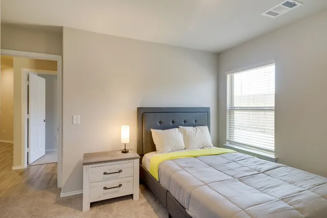 a bedroom with a bed and a window