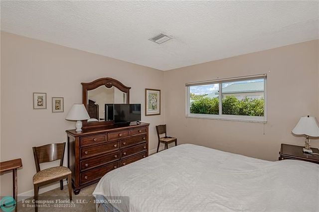 a bedroom with a bed and a television