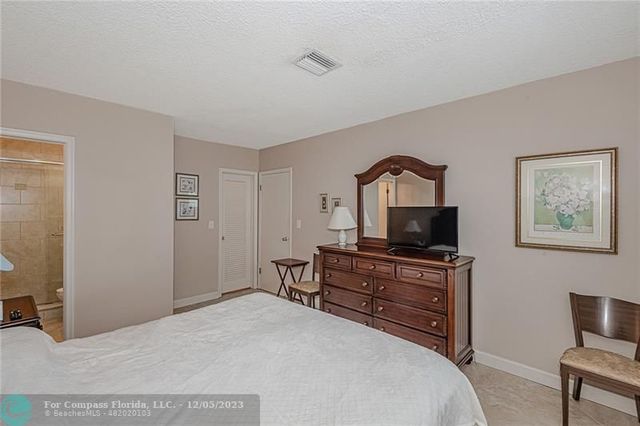 a bedroom with a bed and a television