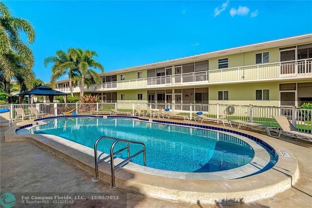 a view of a swimming pool with a lounge chair