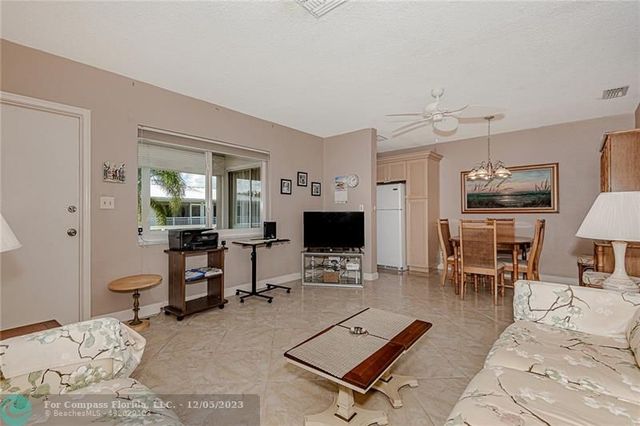a living room with furniture a rug and a flat screen tv
