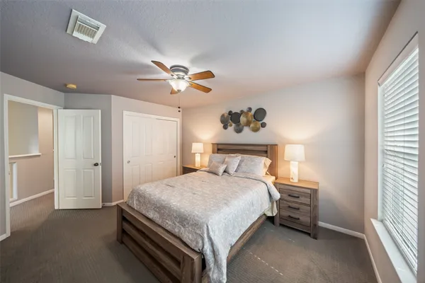 a bedroom with a bed and window