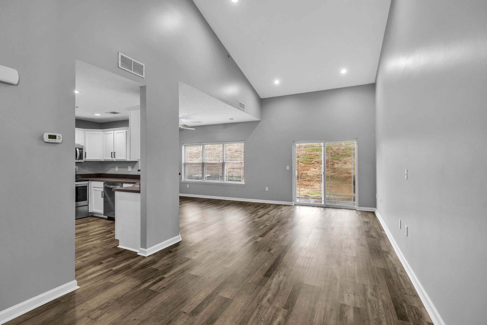 2008 Lavender Court Spring Hill, TN 37174 - Photo 9 of 51 wooden floor in an empty room with a kitchen