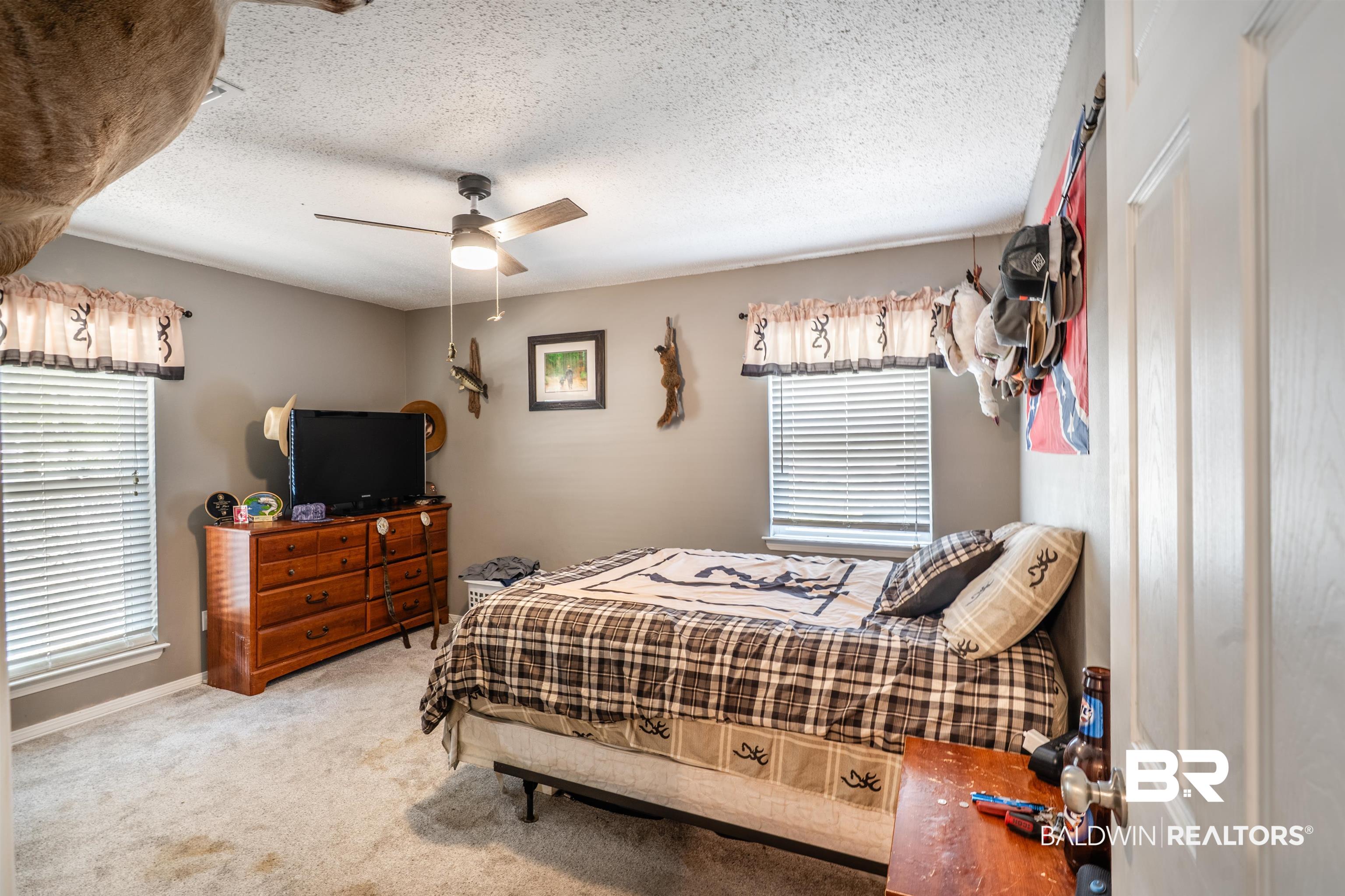 7669 Kali Oka Road Saraland, AL 36571 - Photo 14 of 29 Carpeted bedroom with a textured ceiling and a ceiling fan