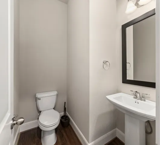 a bathroom with a sink toilet and a mirror