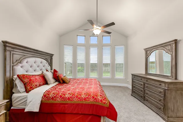 a bedroom with a large bed and a large window