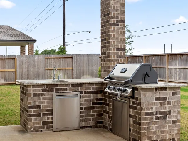 a view of a house with a yard and sitting area
