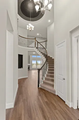a view of entryway and hall with wooden floor