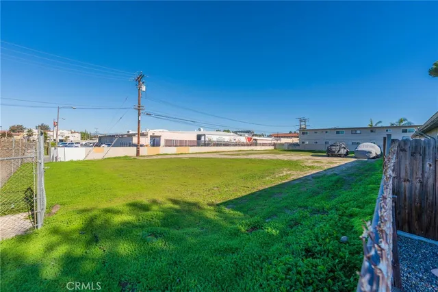 a view of a park with a road and plants