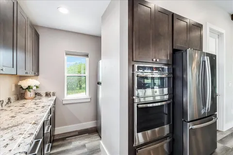 a kitchen with a refrigerator and a window