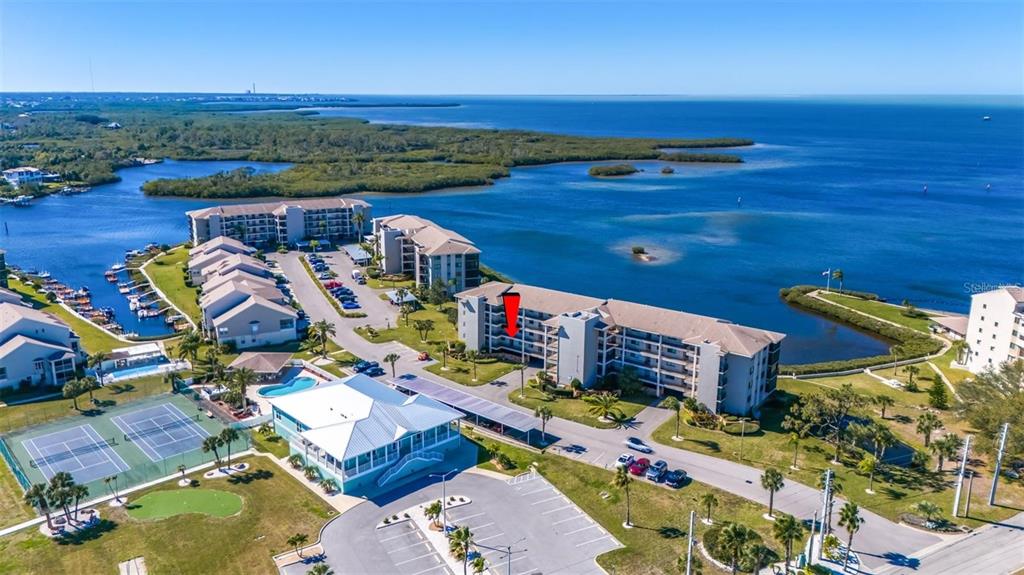 an aerial view of a houses with a ocean view