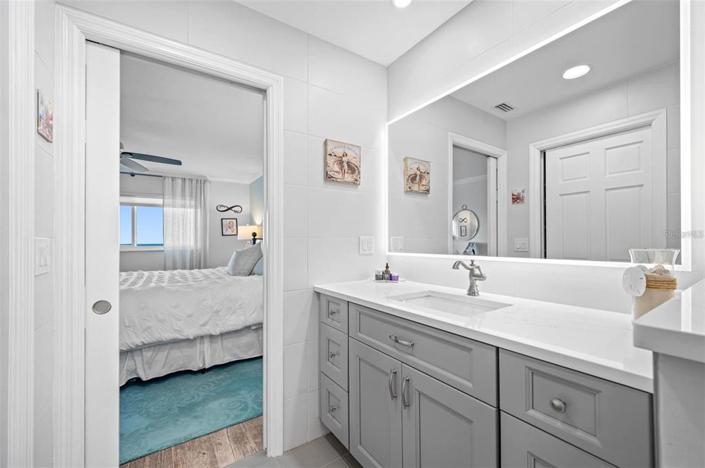 8251 Brent Street, Unit 912 Port Richey, FL 34668 - Photo 19 of 84 a en suite bathroom with a double vanity sink and mirror