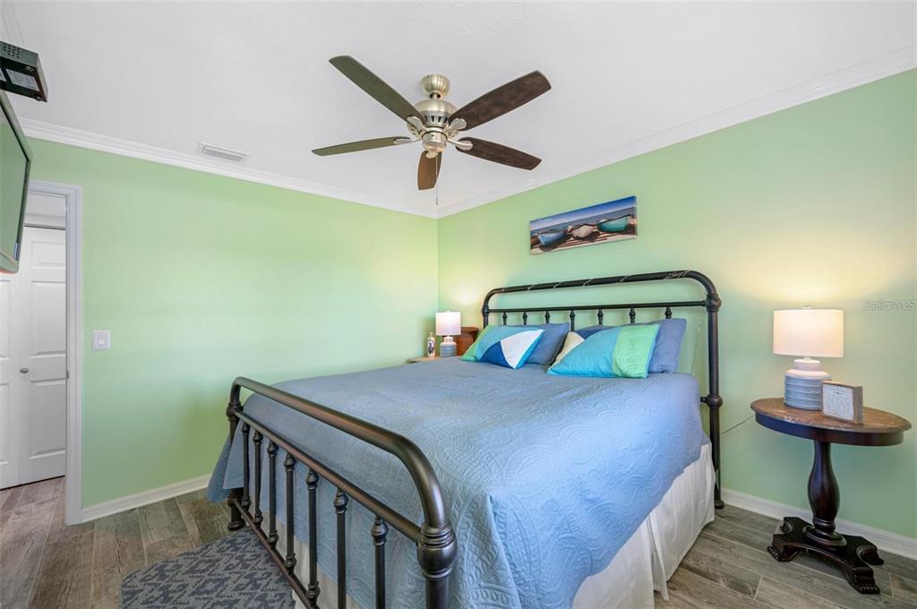 8251 Brent Street, Unit 912 Port Richey, FL 34668 - Photo 21 of 84 a bedroom with a bed and a chandelier