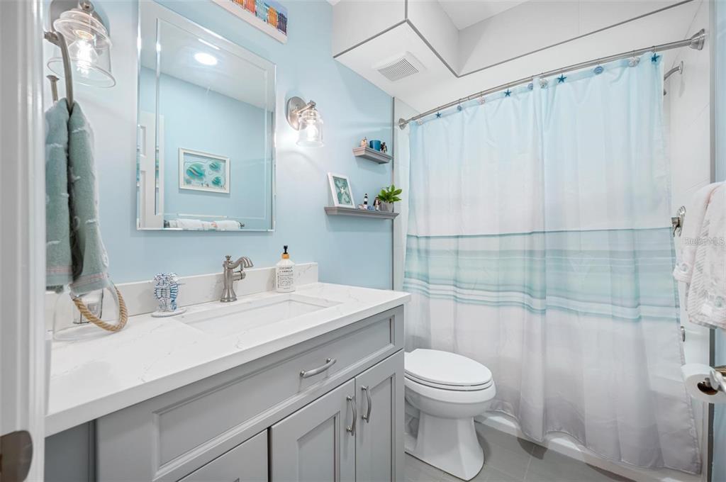 8251 Brent Street, Unit 912 Port Richey, FL 34668 - Photo 22 of 84 a bathroom with a sink a toilet and shower