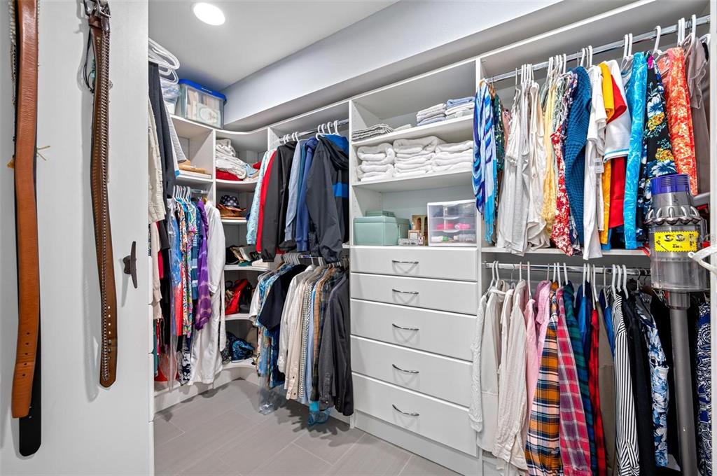 8251 Brent Street, Unit 912 Port Richey, FL 34668 - Photo 25 of 84 a view of walk in closet with clothes