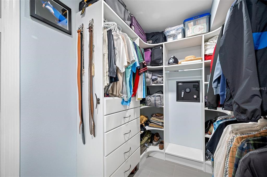 8251 Brent Street, Unit 912 Port Richey, FL 34668 - Photo 26 of 84 a view of walk in closet with clothes and shoes
