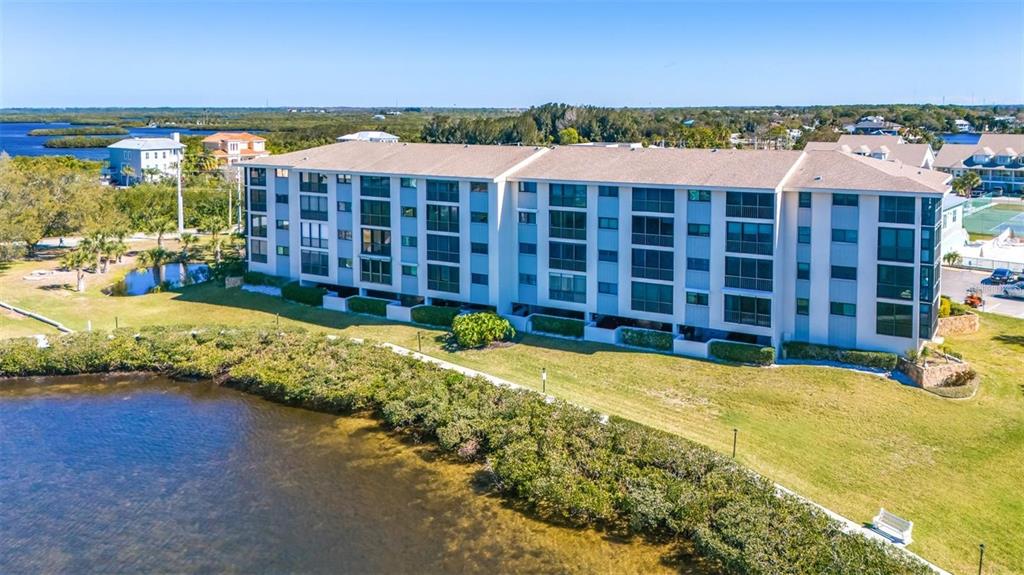 8251 Brent Street, Unit 912 Port Richey, FL 34668 - Photo 61 of 84 a view of a swimming pool with an outdoor space and seating area