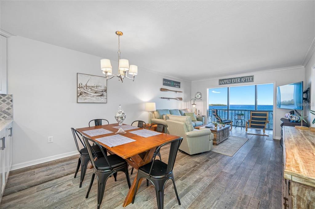 8251 Brent Street, Unit 912 Port Richey, FL 34668 - Photo 7 of 84 a view of a dining room with furniture window and wooden floor