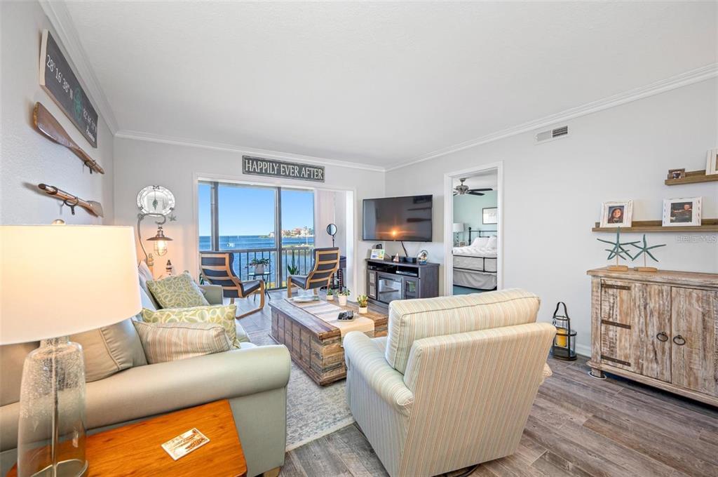 8251 Brent Street, Unit 912 Port Richey, FL 34668 - Photo 71 of 84 a living room with furniture and a flat screen tv