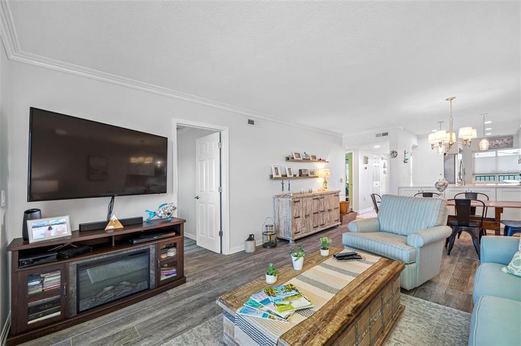 8251 Brent Street, Unit 912 Port Richey, FL 34668 - Photo 72 of 84 a living room with furniture and a flat screen tv