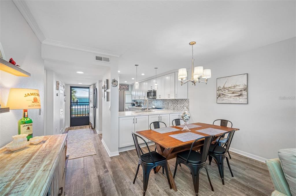 8251 Brent Street, Unit 912 Port Richey, FL 34668 - Photo 74 of 84 a view of a dining room with furniture and chandelier