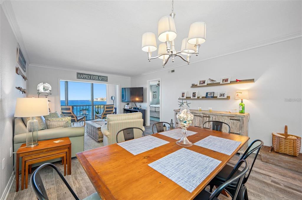 8251 Brent Street, Unit 912 Port Richey, FL 34668 - Photo 75 of 84 a view of a dining room with furniture and a chandelier