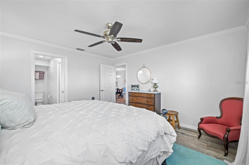 8251 Brent Street, Unit 912 Port Richey, FL 34668 - Photo 80 of 84 a bedroom with a bed table chair and window