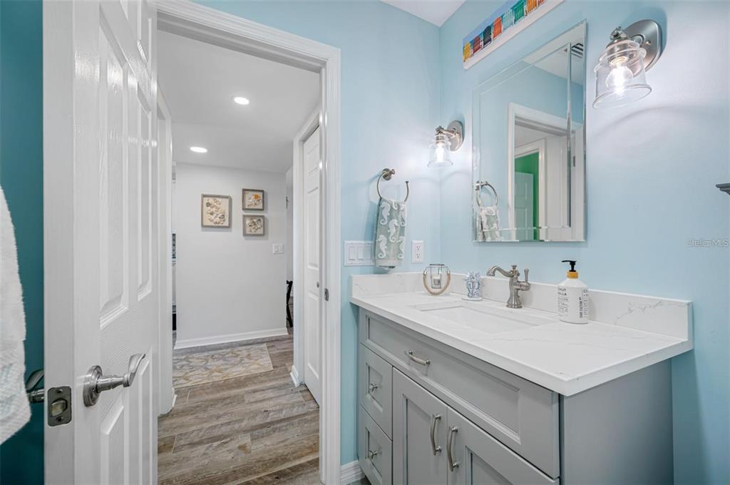 8251 Brent Street, Unit 912 Port Richey, FL 34668 - Photo 83 of 84 a bathroom with a sink and a mirror