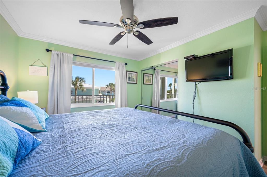 8251 Brent Street, Unit 912 Port Richey, FL 34668 - Photo 84 of 84 a view of a livingroom with a flat screen tv wooden floor and a ceiling fan