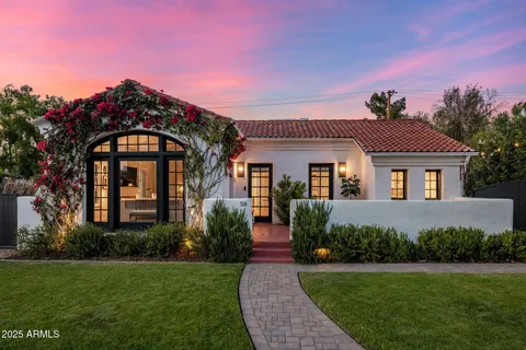 a front view of a house with garden