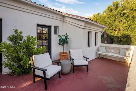 a backyard of a house with outdoor seating