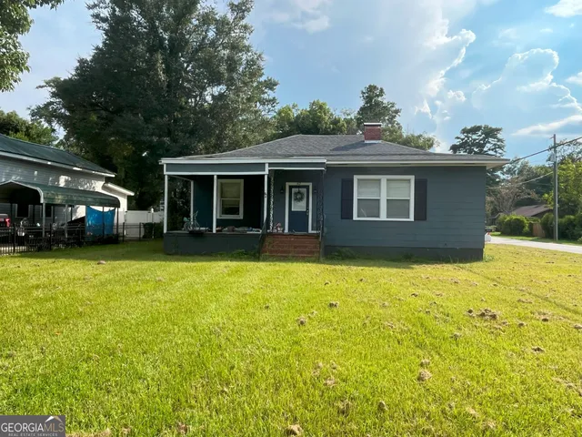 a view of a house with a yard and garage