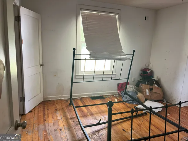 a view of a room with wooden floor and windows