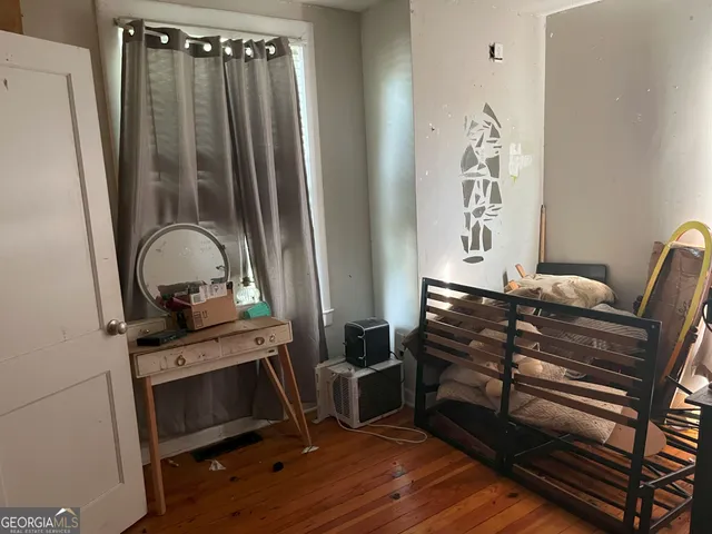 a view of bedroom with furniture and wooden floor