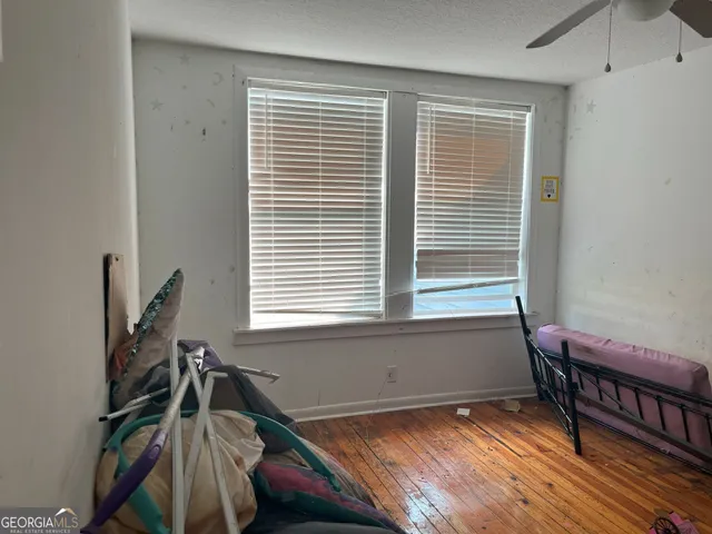 a view of a room with windows and wooden floor