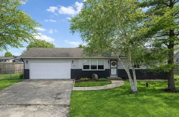 a front view of house with a garden