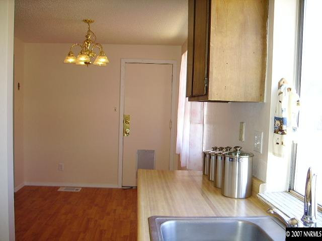 3465 Becard Lane Reno, NV 89508 - Photo 5 of 9 a view of a dining room with furniture and wooden floor