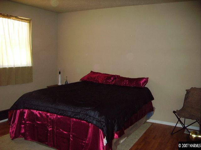 3465 Becard Lane Reno, NV 89508 - Photo 6 of 9 a bedroom with a bed and a chair