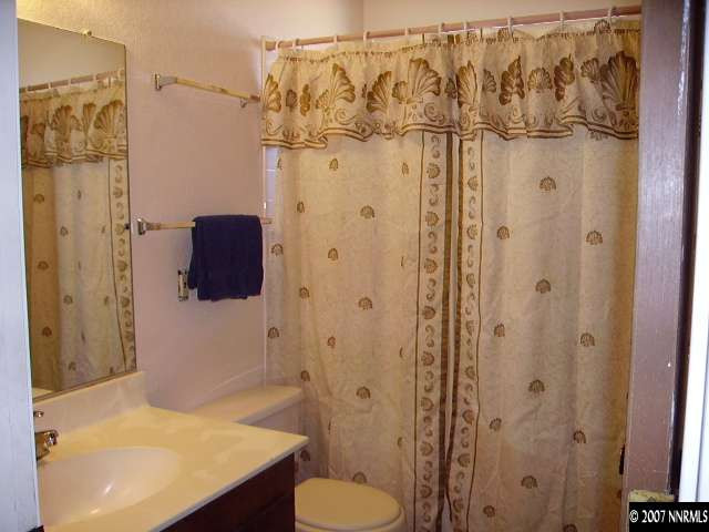 3465 Becard Lane Reno, NV 89508 - Photo 7 of 9 a bathroom with a shower and a sink