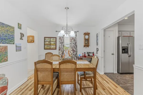 a view of a dining room with furniture and chandelier