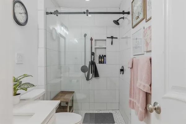 a bathroom with a shower toilet and sink