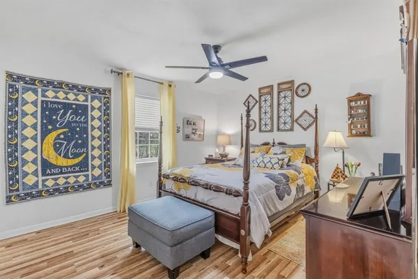 a bedroom with furniture and wooden floor