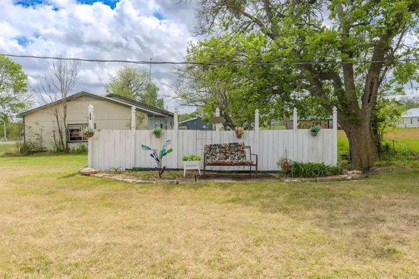 a view of a house with pool and a yard