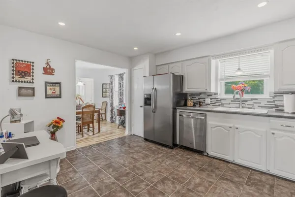 a kitchen with refrigerator and cabinets
