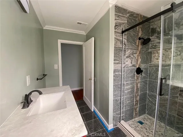 a bathroom with a shower and a sink