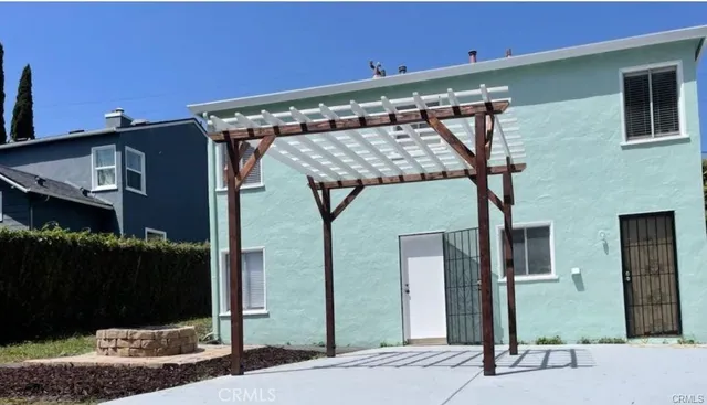 a view of a wooden house and a yard